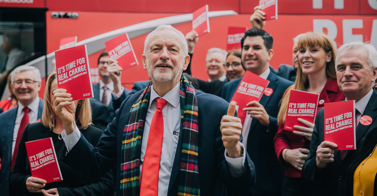 Jeremy Corbyn and front bench holding copies of the 2019 manifesto