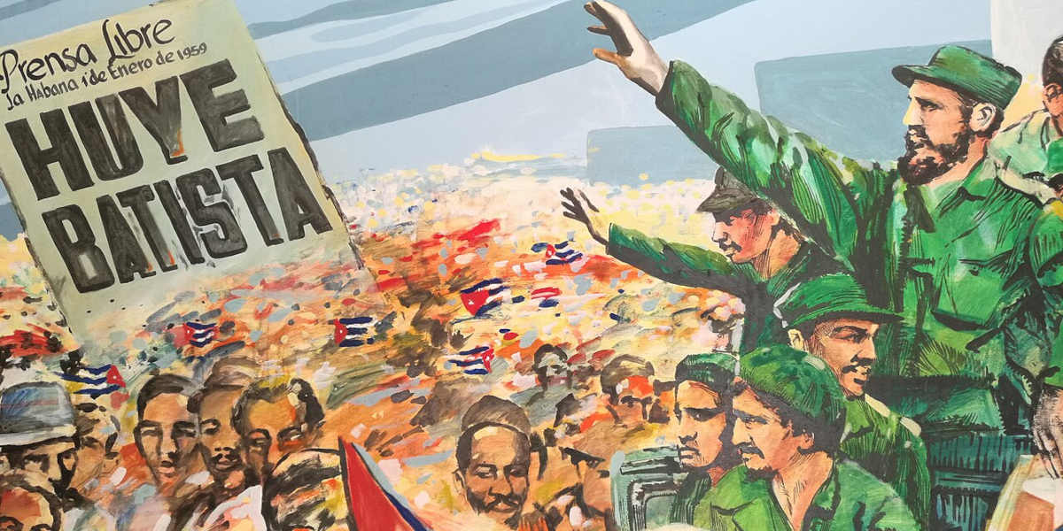 A mural showing Fidel Castro waiving at a crowd who are holding a sign commemorating the former dictator Fulgencio Batista's fall from power on 1st January 1959
