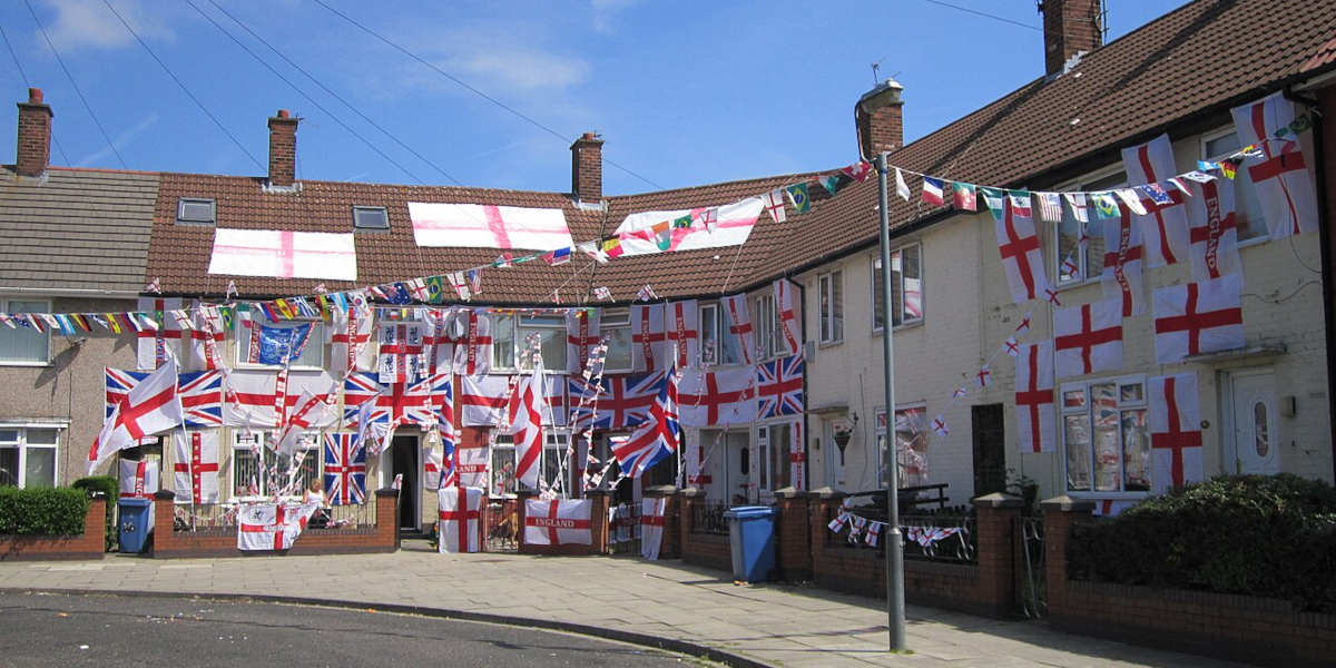 A street showing houses decorated in the England flag
