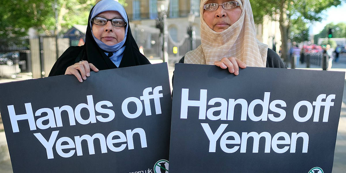 Two women holding up signs reading 'Hands off Yemen' at a protest in London in 2018