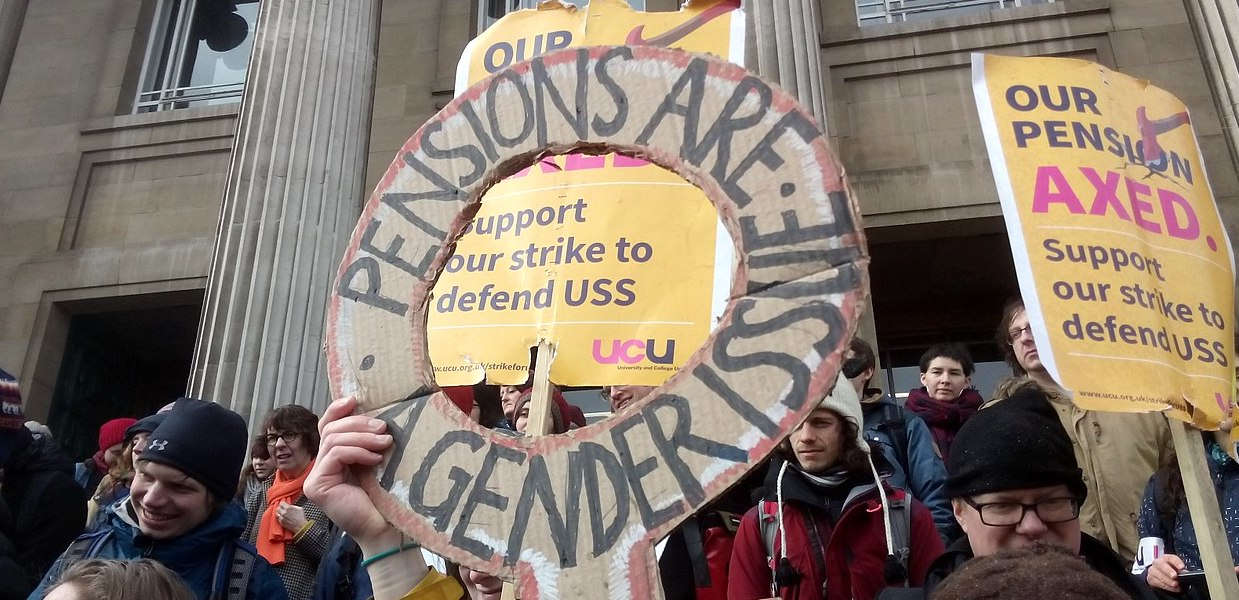 A cardboard placard reads: Pensions are a Gender Issue at a UCU picket line