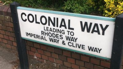 A street sign in Watford marks Colonial Way leading to Rhodes Way, Imperial Way and Clive Way