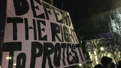 A protest banner reading Defend the right to Protest