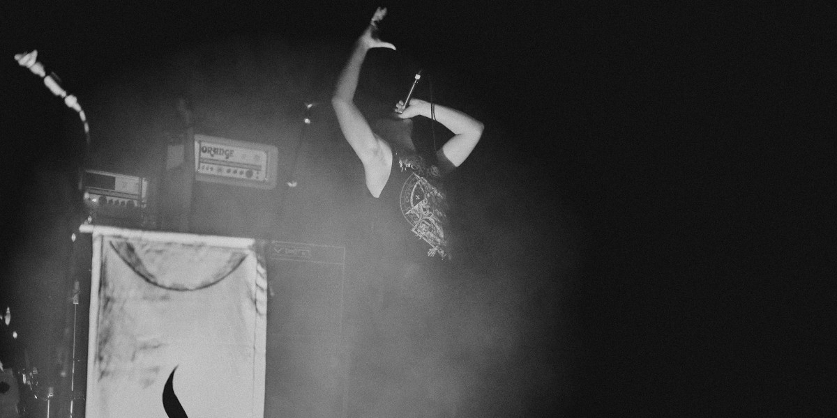 A black and white photo of Dan Ray'd vocalist Simon Barr during a live show