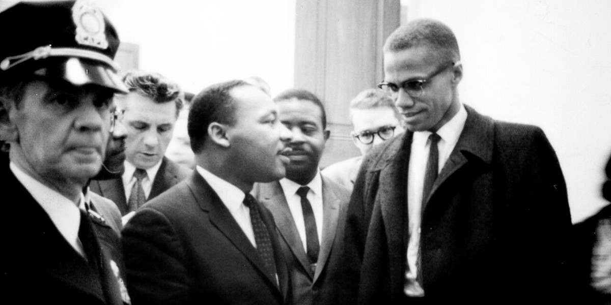 A black and white photograph of Civil Rights leader Martin Luther King Jr. (left) with Malcolm X (right)
