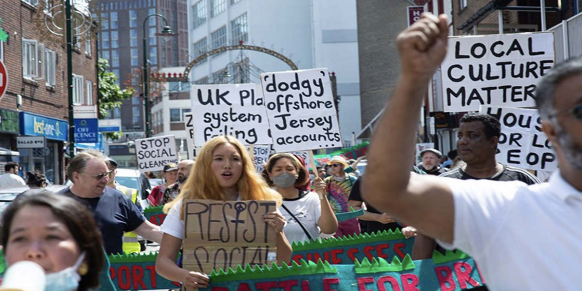 A large colourful Save Brick Lane protest