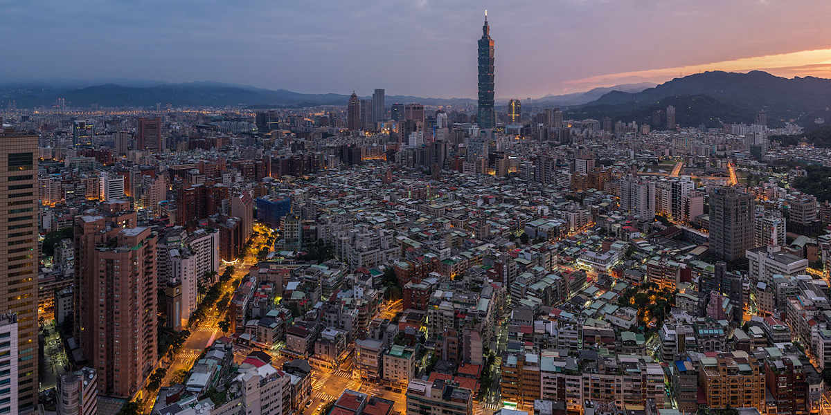 A cityscape photograph of a sunrise over Taipei, Taiwan