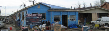 People sitting in front of a help station run by the Common Ground Collective mutual aid network in New Orleans, Louisiana