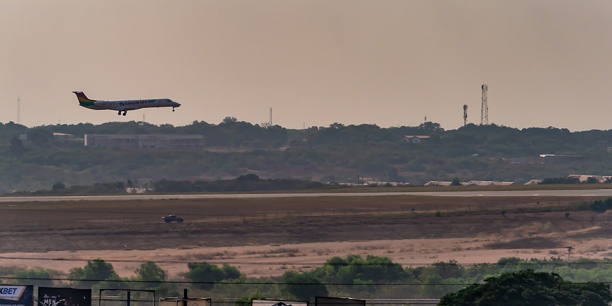 An aeroplane taking off at sunset from Kotaka International Airport in Accra, Ghana