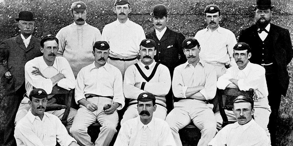 A black and white photograph of a cricket team from 1985