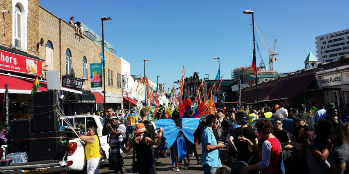 People dancing, waving flags at Hackney Carnival in 2016