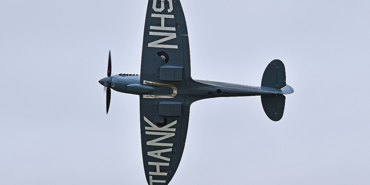 A World War Two spitfire flies overhead thanking the NHS staff for their service throughout the pandemic, 2020.