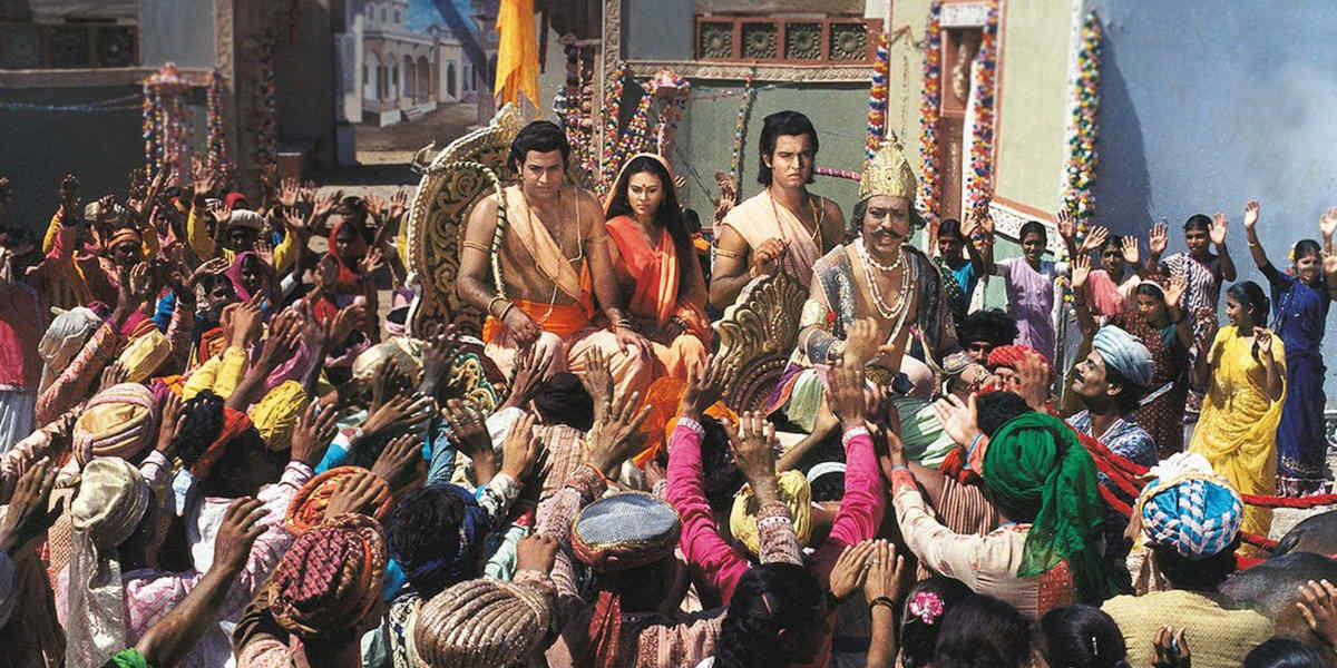 A still from a 1980s television series, <i>Ramayan</i>, showing figures Lord Ram with his brother Laxman and wife Sita in a chariot surrounded by crowds of people