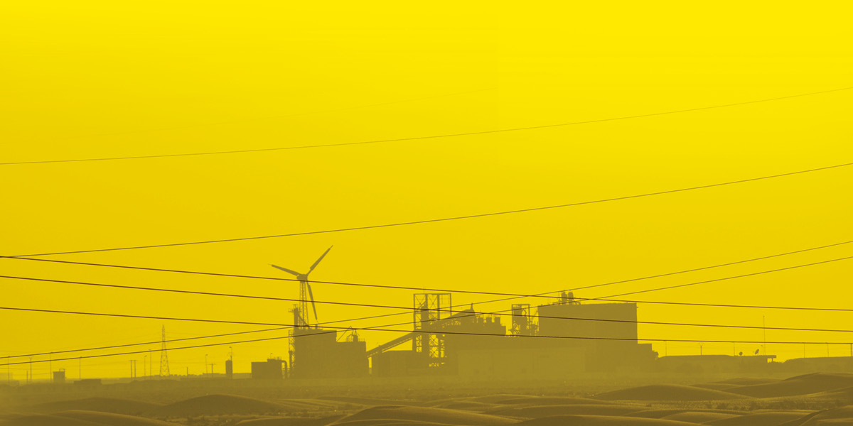 The outline of a wind farm complex in a vast desert is shown against a yellow background