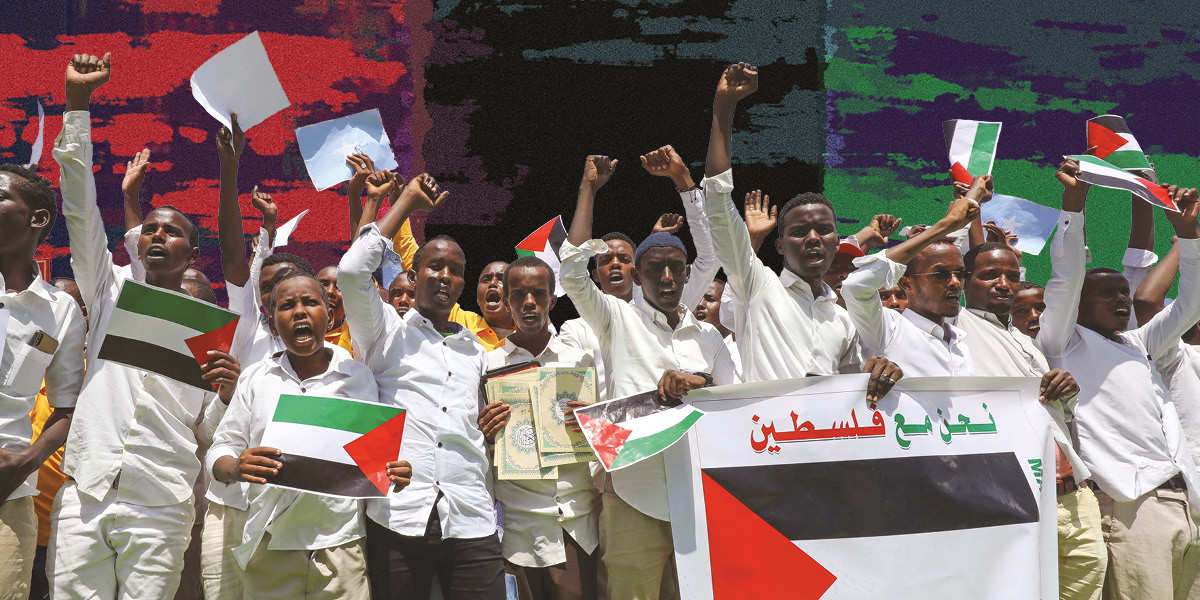 A group of young Somali students wearing white shirts hold Palestinian flags and stand with freedom fists raised