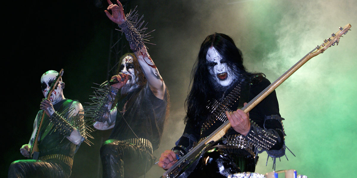 Three members of the band Gorgoroth wearing black and white facepaint playing live