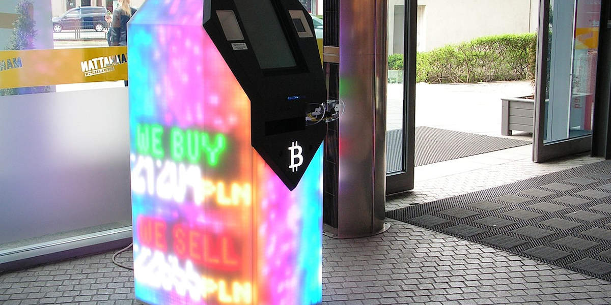 A bitcoing machine illuminated with multiple coloured lights in a shopping centre in Gdańsk, Poland