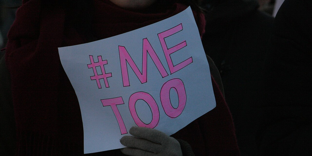 A piece of paper reading in #MeToo in pink letters