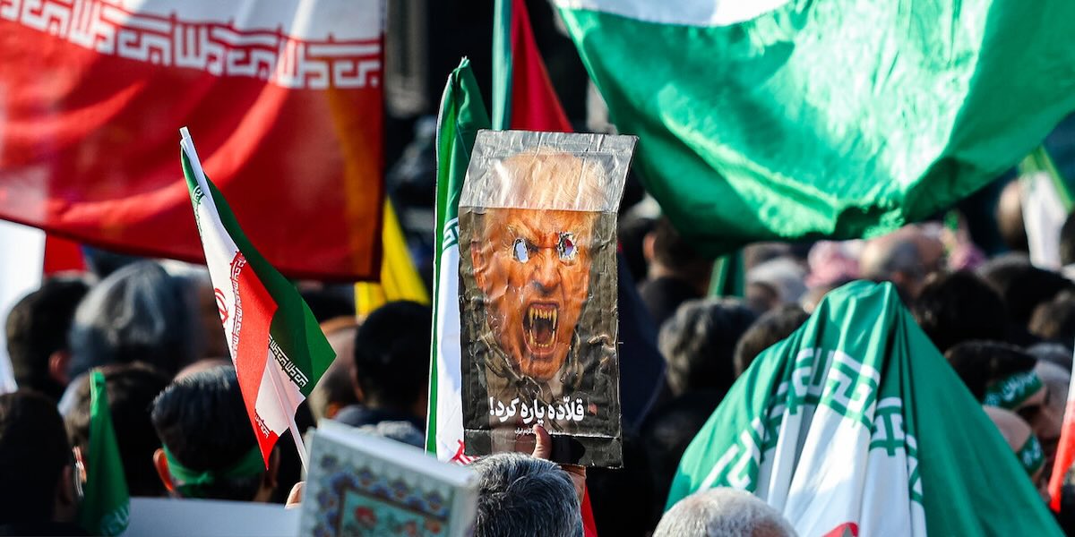 A poster of a demonic Donald Trump among a sea of Iranian flags
