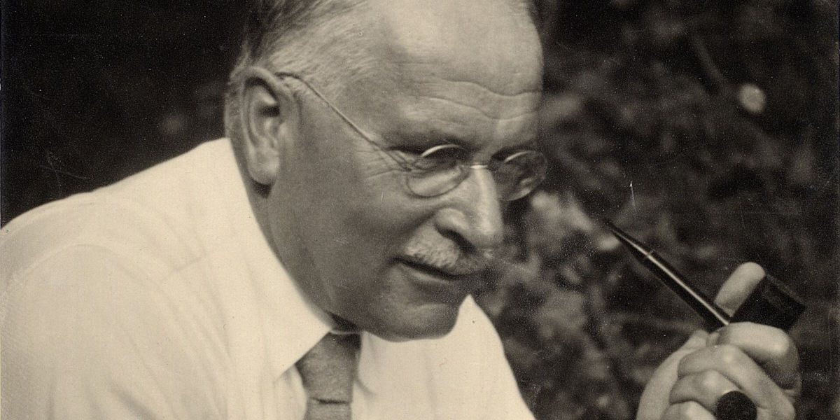 A photograph of Carl Jung holding a pipe